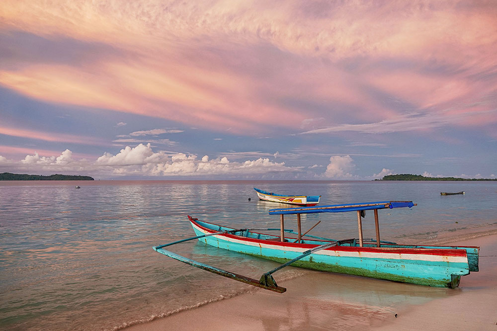 old boat on a pastel sunset beach