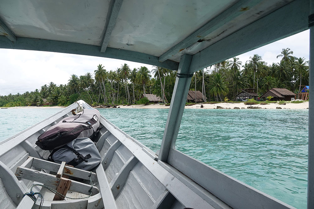 POV approaching the island and bungalows in a boat