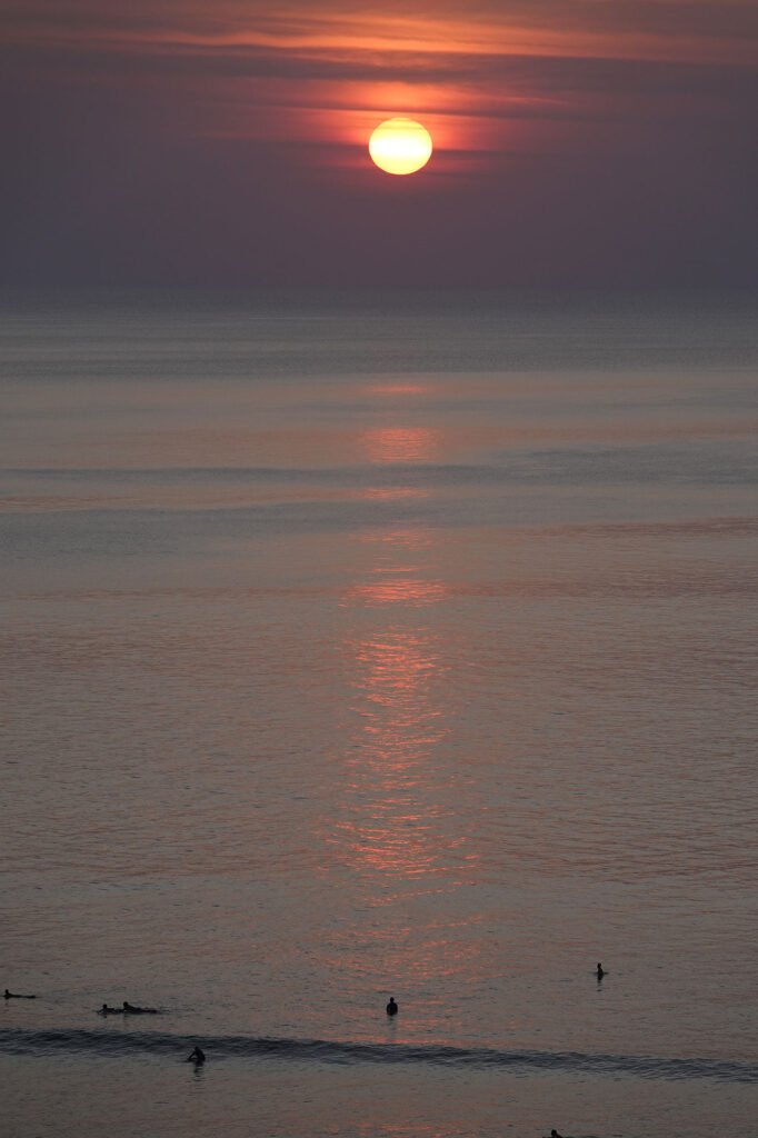 beach tourists and sunset