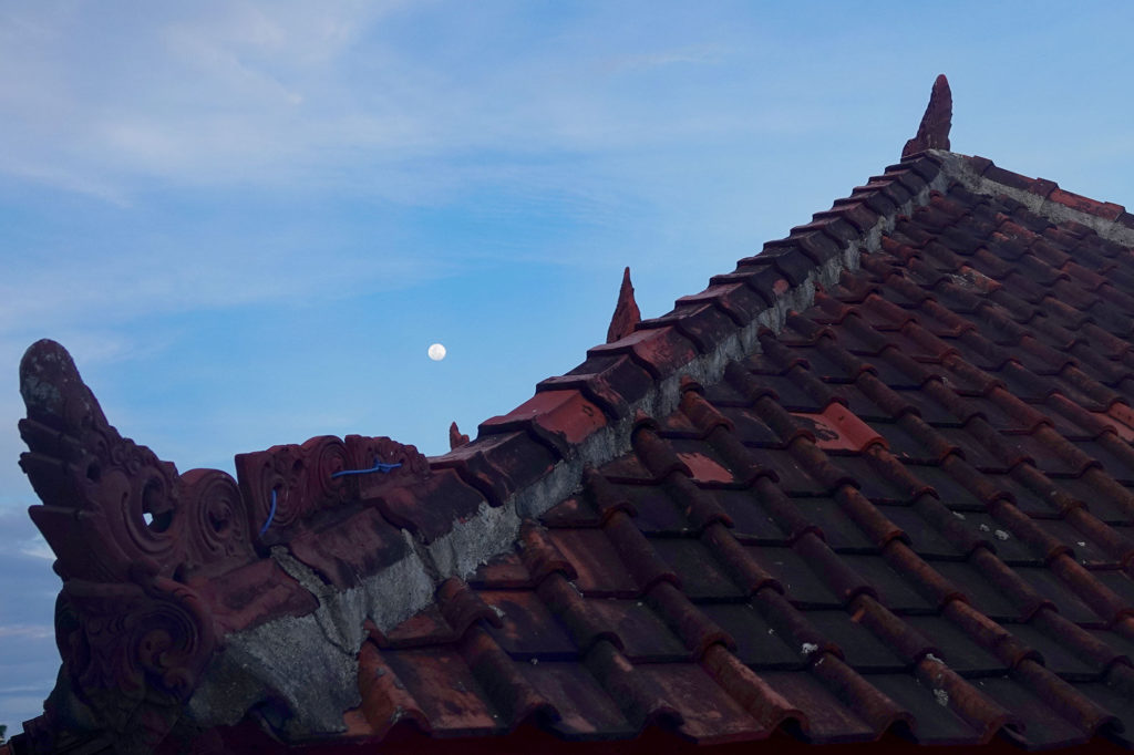 moon over a roof and roof over a head
