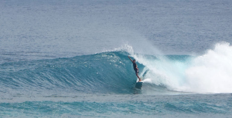 Surfer Enjoying The Waves On Bali Beach