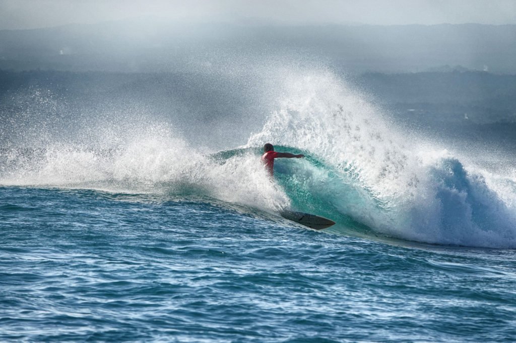 Local surfer Jaya rips on a speedy wave at Lacerations surf spot, on Nusa Lembongan.
