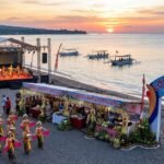 Traditional Balinese dancers perform on stage at Lovina Festival on the beach in North Bali at sunset