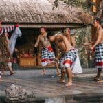 Balinese men in traditional poleng checkered sarongs during ceremony