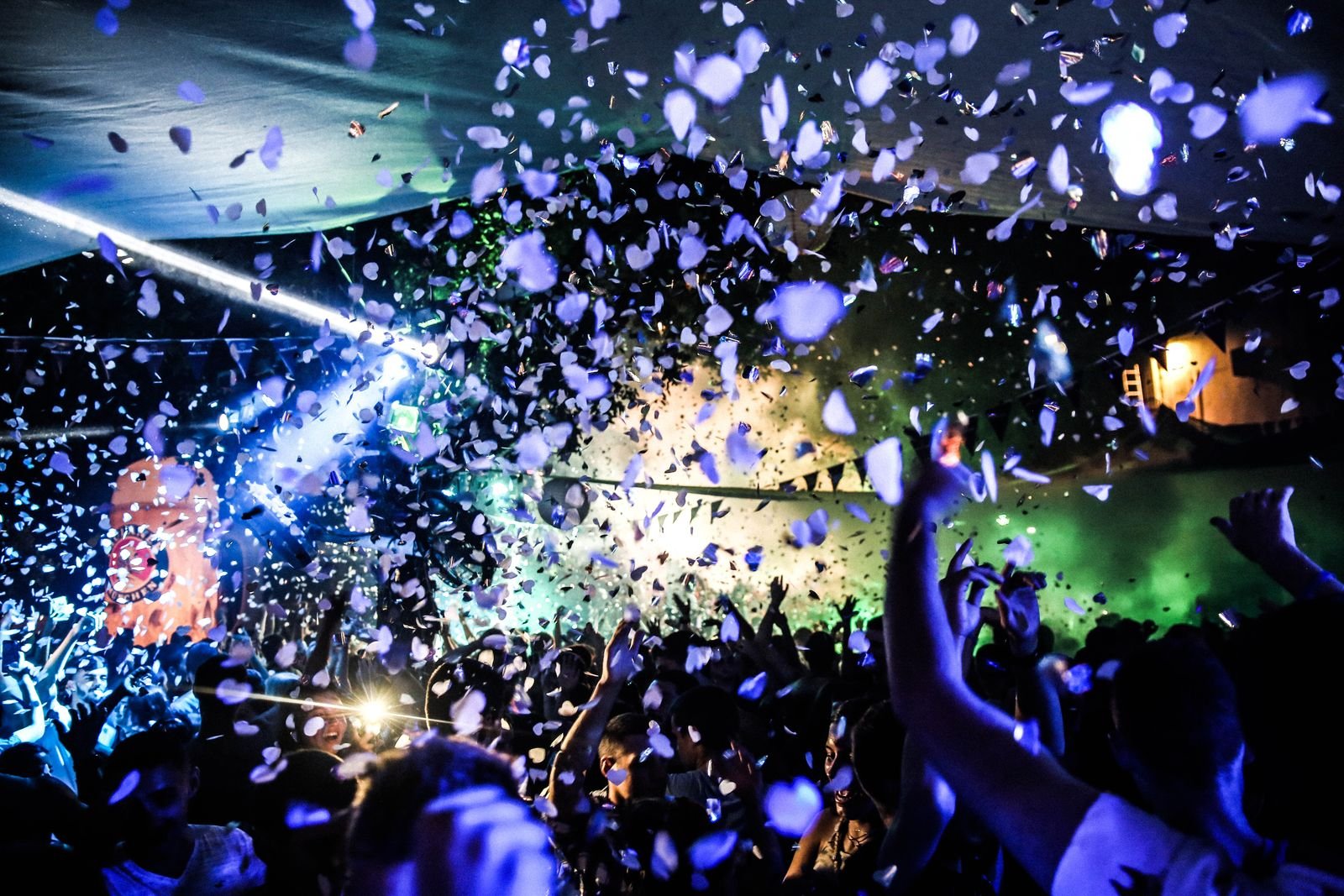 Crowd dancing under coloured lights at a nightclub, evoking the Afro-house energy of Junction Africa at The Mesa Bali in Berawa, Bali.
