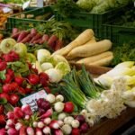Fresh organic vegetables displayed on a market stall, evoking the Samadi Sunday Farmers Market in Canggu, Bali.