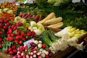 Fresh organic vegetables displayed on a market stall, evoking the Samadi Sunday Farmers Market in Canggu, Bali.